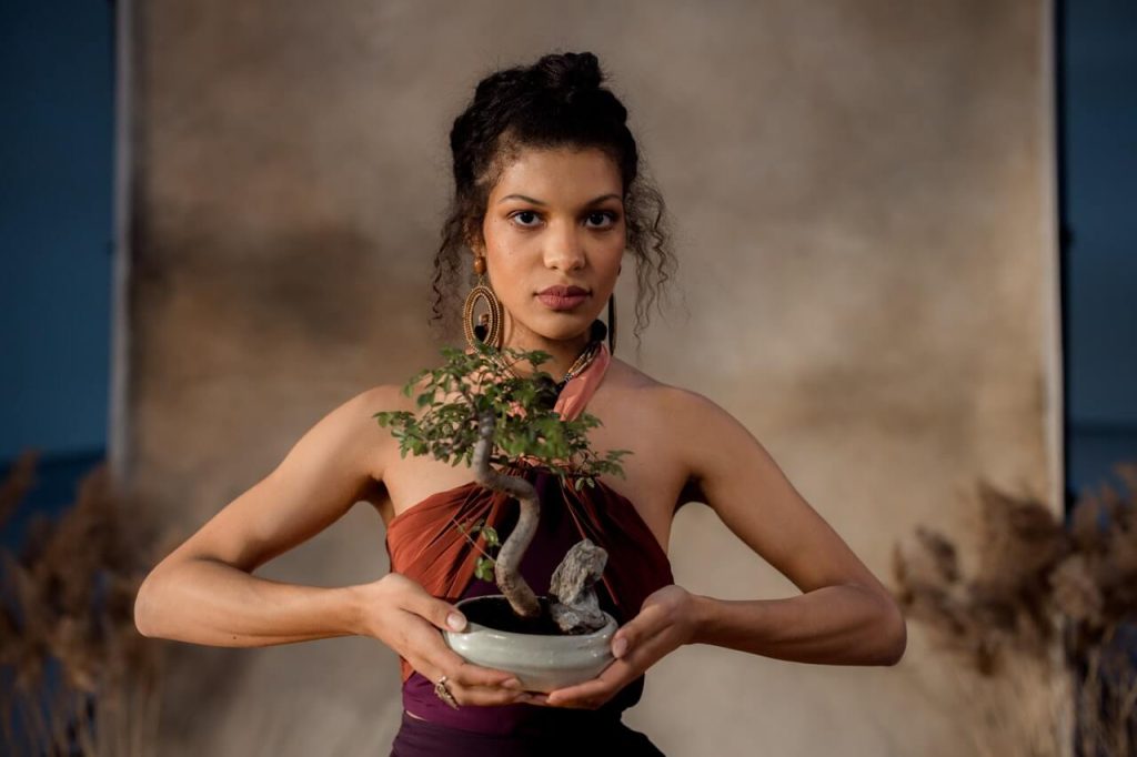 Girl holding a bonsai tree